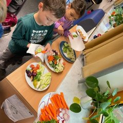 The children of class 2a help themselves to a buffet of healthy snacks