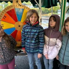 The children of class 4b stand in front of the wheel of fortune mobile.