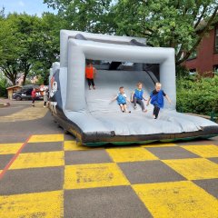 Children slide out of the obstacle course.