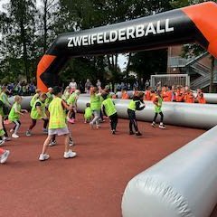 Children play two-a-side ball against each other.