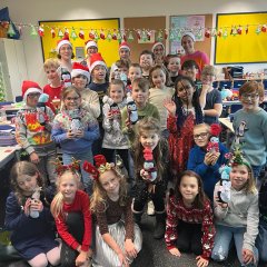 Class 3a proudly shows off the penguins they have made.
