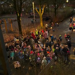 The impatient children are waiting for the school doors to change for them.