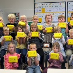 Children from class 1b show off their organic lunch boxes.