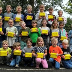 Children from class 1c show off their organic lunch boxes.