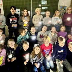 Third grade children with flashlights.