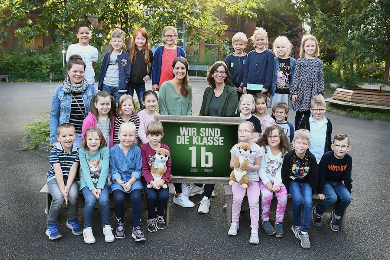 Children with their class teachers and the class animal