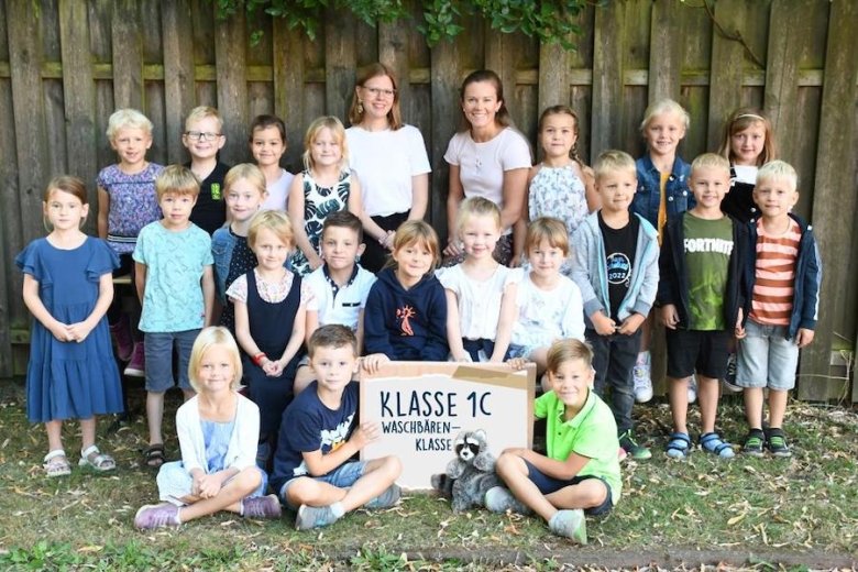 Children with their class teacher and the class animal