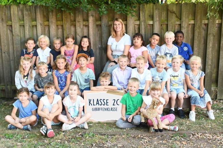 Children with their class teacher and the class animal