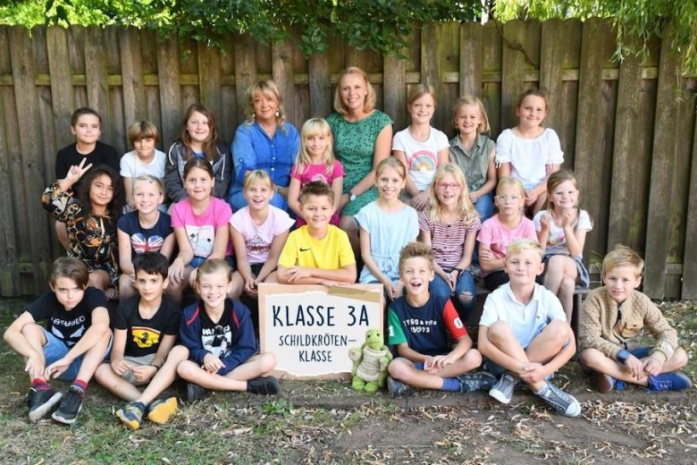 Children with their class teachers and the class animal