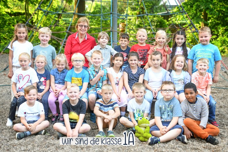 Children of the frog class with their class teacher and the class animal