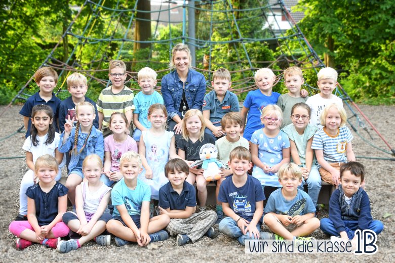 Children of the penguin class with their class teacher and the class animal