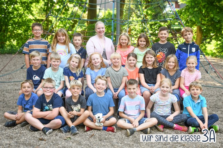 Children of the polar bear class with their class teacher and the class animal