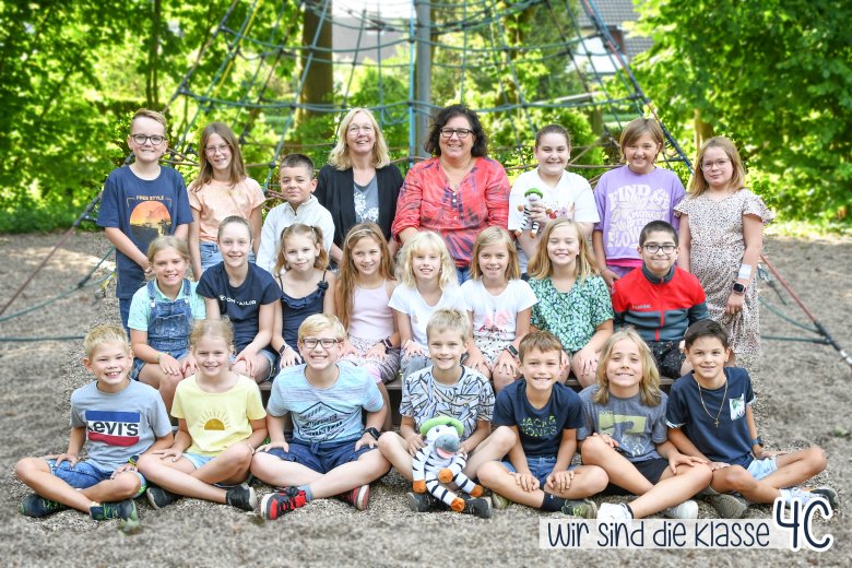 Children of the zebra class with their class teacher and the class animal