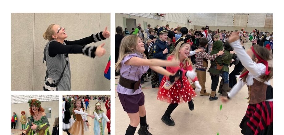 Impresiones de la celebración en el gimnasio. Niños disfrazados bailan al ritmo de la música.